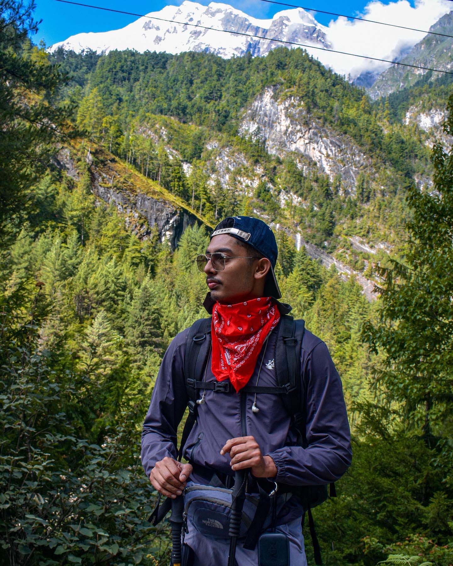 Trekker of Trek 8586 with red bandana posing infront of scenic trails of Tilicho Trek, Annapurna Region