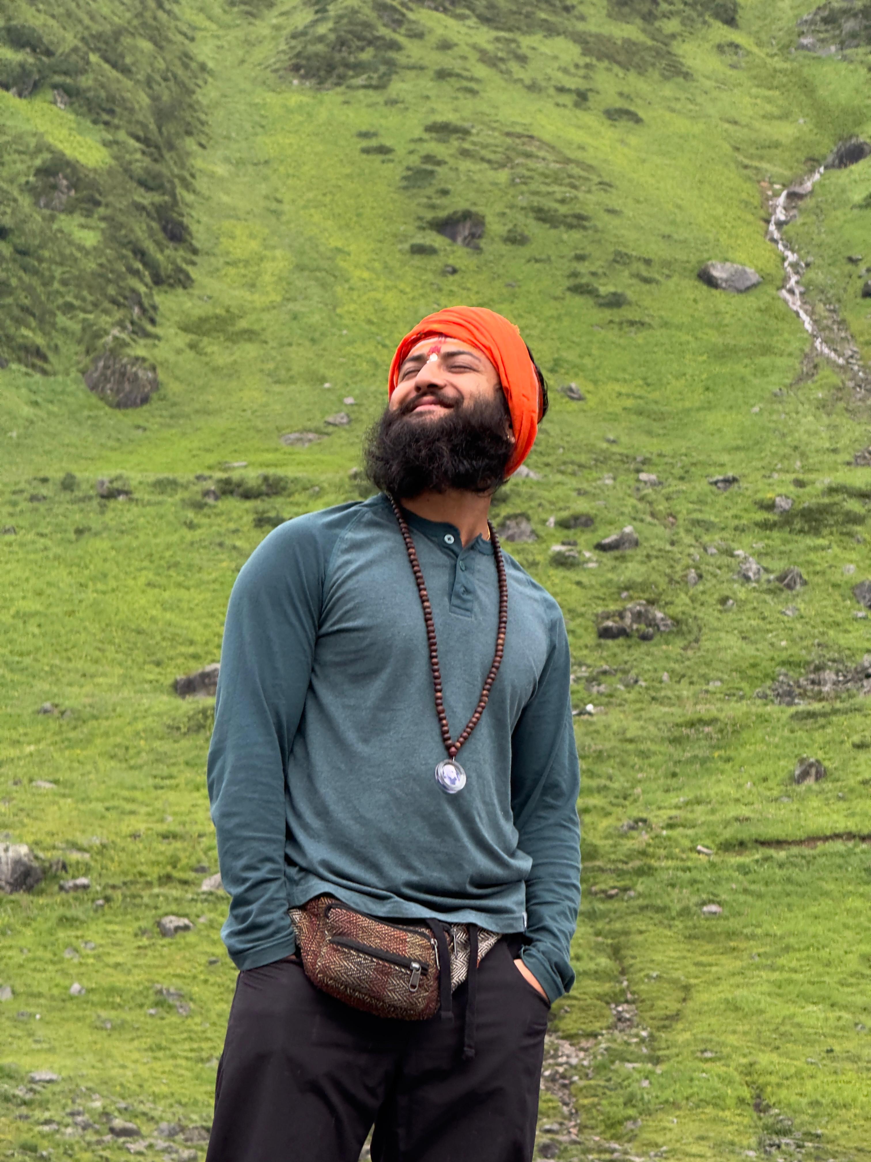 Manoj Basnet posing in front of a vast open ground, highlighting the natural beauty and scenic landscapes of Nepal.