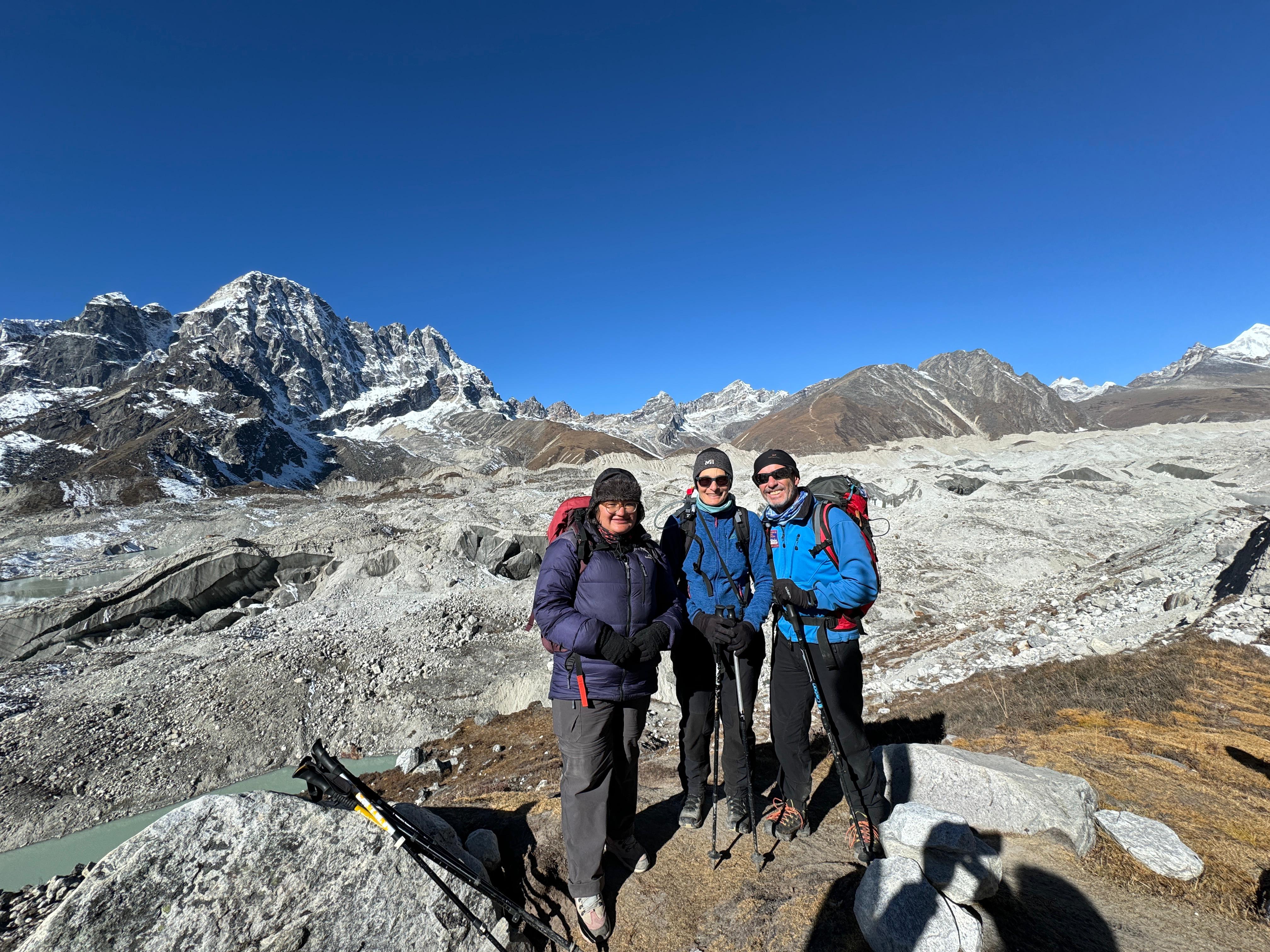 Climbers in the Everest Region during their visit to Gokyo Lake, surrounded by breathtaking snow-capped peaks and the tranquil beauty of the pristine alpine lake.